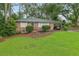 Charming brick home featuring a well-manicured lawn and lush landscaping, complete with an attached carport at 1849 Clay Sw Rd, Mableton, GA 30126
