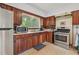 Well-lit kitchen with stainless steel appliances, tile flooring, and warm wooden cabinets at 1849 Clay Sw Rd, Mableton, GA 30126