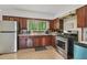 Kitchen featuring stainless steel appliances, tile floors, and warm wooden cabinets at 1849 Clay Sw Rd, Mableton, GA 30126