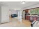 Open concept kitchen with stainless steel refrigerator and sliding glass door to the backyard at 1849 Clay Sw Rd, Mableton, GA 30126