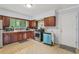 Bright kitchen featuring stainless steel appliances, tile floors, and wooden cabinetry at 1849 Clay Sw Rd, Mableton, GA 30126