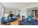 Open-concept living area with hardwood floors, a dining table, and comfortable blue furniture, perfect for entertaining at 1849 Clay Sw Rd, Mableton, GA 30126