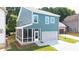 Exterior view features a screened porch, lush lawn and a two-car garage at 1922 Perry Nw Blvd, Atlanta, GA 30318