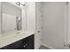 Well-lit bathroom features a modern vanity with a sleek countertop and a framed mirror at 1922 Perry Nw Blvd, Atlanta, GA 30318
