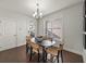 Cozy dining area with modern chandelier and views through the window to the outdoors at 1922 Perry Nw Blvd, Atlanta, GA 30318