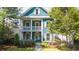Charming two-story home featuring a covered porch, well-maintained lawn, and inviting curb appeal at 1922 Perry Nw Blvd, Atlanta, GA 30318