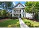Charming two-story home with a welcoming front porch and beautifully landscaped front yard at 1922 Perry Nw Blvd, Atlanta, GA 30318