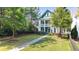 Beautiful two-story home featuring a well-manicured lawn and charming front porch, perfect for relaxing at 1922 Perry Nw Blvd, Atlanta, GA 30318