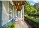 Inviting covered front porch with stylish seating, offering a relaxing outdoor space to enjoy the neighborhood at 1922 Perry Nw Blvd, Atlanta, GA 30318