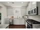 This kitchen features stainless steel appliances, granite countertops and sleek cabinetry at 1922 Perry Nw Blvd, Atlanta, GA 30318