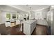 Open kitchen with granite island flows into the living room with fireplace and hardwood floors at 1922 Perry Nw Blvd, Atlanta, GA 30318