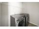 Convenient laundry room includes modern washer and dryer with an overhead shelf at 1922 Perry Nw Blvd, Atlanta, GA 30318