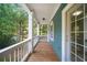 Relaxing porch with wood floors, white railings and columns, offering serene views of the surrounding trees at 1922 Perry Nw Blvd, Atlanta, GA 30318