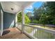A covered porch offers an inviting outdoor space to enjoy the lush greenery and neighborhood views at 1922 Perry Nw Blvd, Atlanta, GA 30318