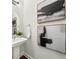 Stylish powder room with pedestal sink, decorative mirror, and modern wall art at 1922 Perry Nw Blvd, Atlanta, GA 30318