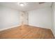 An empty room with hardwood floors and a door leading to the home's other spaces at 2803 3Rd Sw Ave, Atlanta, GA 30315