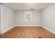 Bedroom featuring hardwood floors, a window, and neutral paint for a calming atmosphere at 2803 3Rd Sw Ave, Atlanta, GA 30315