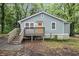 Charming bungalow with light blue siding, wood porch and stairs, and lush greenery at 2803 3Rd Sw Ave, Atlanta, GA 30315