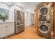 Stainless steel refrigerator, stackable washer/dryer, and wood flooring at 2803 3Rd Sw Ave, Atlanta, GA 30315
