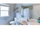 Bright bathroom features a toilet, window, vanity with sink and shower/tub combination at 4084 Fort Sumter Nw Lndg, Acworth, GA 30101