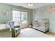 Charming Bedroom featuring a crib, glider chair, and soothing wall decor at 4084 Fort Sumter Nw Lndg, Acworth, GA 30101