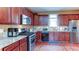 Kitchen with stainless steel appliances, granite countertops, tiled backsplash, and cherry wood cabinets at 4084 Fort Sumter Nw Lndg, Acworth, GA 30101