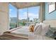 Bedroom view highlights large windows, cityscape, and serene decor for relaxation at 855 Peachtree Ne St # 501, Atlanta, GA 30308