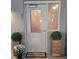 Condo entrance with 'Welcome' mat and potted plants at 855 Peachtree Ne St # 501, Atlanta, GA 30308
