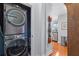 Stackable washer and dryer tucked into a hallway closet at 855 Peachtree Ne St # 501, Atlanta, GA 30308