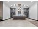 Lobby featuring modern chandelier, reception desk, and sleek tiled floors creates a welcoming and sophisticated entrance at 855 Peachtree Ne St # 501, Atlanta, GA 30308
