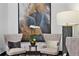 Cozy sitting area featuring comfortable armchairs, stylish artwork, and a decorative floor lamp at 855 Peachtree Ne St # 501, Atlanta, GA 30308