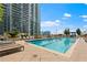 Stunning rooftop pool with lounge chairs offers a luxurious city escape and amazing view of surrounding high-rise buildings at 855 Peachtree Ne St # 501, Atlanta, GA 30308