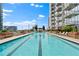 A luxurious rooftop pool is framed by comfortable loungers and lush landscaping, with city views stretching to the horizon at 855 Peachtree Ne St # 501, Atlanta, GA 30308