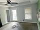 Bedroom featuring neutral carpeting, a tray ceiling, and outdoor access at 1539 Beecher Sw St, Atlanta, GA 30310