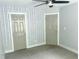 Bedroom featuring ceiling fan, doors and patterned accent wall at 1539 Beecher Sw St, Atlanta, GA 30310
