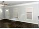 Large living room featuring windows, hardwood floors, and a white front door at 1539 Beecher Sw St, Atlanta, GA 30310
