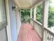 View of a covered porch with wood flooring and white railings at 1539 Beecher Sw St, Atlanta, GA 30310
