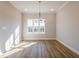 Bright dining room featuring wood floors, a modern chandelier, and a large window at 1980 Deco Dr, Kennesaw, GA 30144