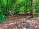 Scenic trail through lush woods, beckoning hikers and nature enthusiasts to explore its tranquil paths at 1980 Deco Dr, Kennesaw, GA 30144