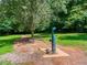 Water fountain along a walking trail in a wooded area, inviting passersby to refresh and hydrate during their journey at 1980 Deco Dr, Kennesaw, GA 30144