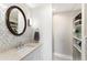 Stylish bathroom with granite countertop, decorative mirror, and nearby storage shelves at 215 Piedmont Ne Ave # 1406, Atlanta, GA 30308