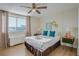 Serene bedroom with a cozy bed, bright window, and modern ceiling fan, ideal for relaxation at 215 Piedmont Ne Ave # 1406, Atlanta, GA 30308