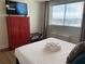 Inviting bedroom featuring a neatly made bed, dresser, and a large window offering scenic views at 215 Piedmont Ne Ave # 1406, Atlanta, GA 30308