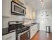 Updated kitchen with stainless steel appliances, white cabinets, and sleek countertops at 215 Piedmont Ne Ave # 1406, Atlanta, GA 30308