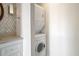 Convenient laundry area includes stacked washer and dryer near a vanity at 215 Piedmont Ne Ave # 1406, Atlanta, GA 30308