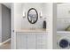 Bright laundry room near the vanity features a stackable washer and dryer at 215 Piedmont Ne Ave # 1406, Atlanta, GA 30308