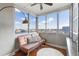 Sunroom with expansive windows offering city views, a comfortable couch and decorative shelving at 215 Piedmont Ne Ave # 1406, Atlanta, GA 30308