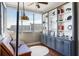 Cozy sunroom features city views, a comfortable couch, and a bookcase with built-in storage at 215 Piedmont Ne Ave # 1406, Atlanta, GA 30308