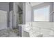 Bathroom featuring a soaking tub, shower and white subway tile at 7434 Absinth Dr, Atlanta, GA 30349
