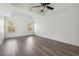 Spacious bedroom featuring a tray ceiling, ceiling fan, and two windows at 7434 Absinth Dr, Atlanta, GA 30349